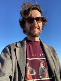 a man wearing sunglasses and a t - shirt